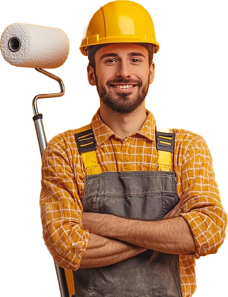 Pintor de obras sorrindo, de capacete amarelo e macacão, com um rolo de pintura