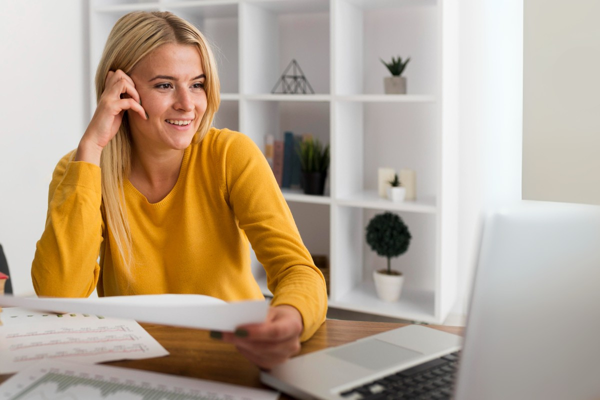 Empresária analisando documentos em frente ao notebook em um ambiente de escritório representando como regularizar uma nota fiscal rejeitada: principais motivos e o que fazer.